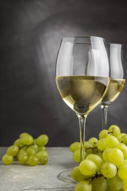 Masanın üzerinde bir bardak beyaz şarap..