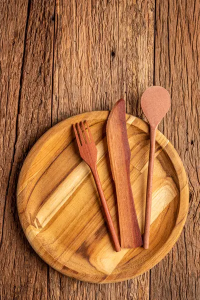 Wooden cutlery on wooden table.