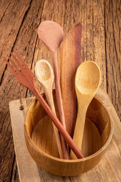 Wooden cutlery on wooden table.