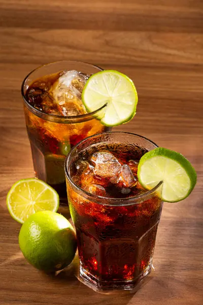 Coke glasses with ice cubes and lemon.