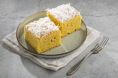 Masanın üzerinde dilimlenmiş hindistan cevizli kek.