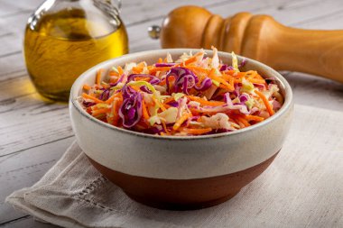 Coleslaw salad with white cabbage, red cabbage and sliced carrots clipart