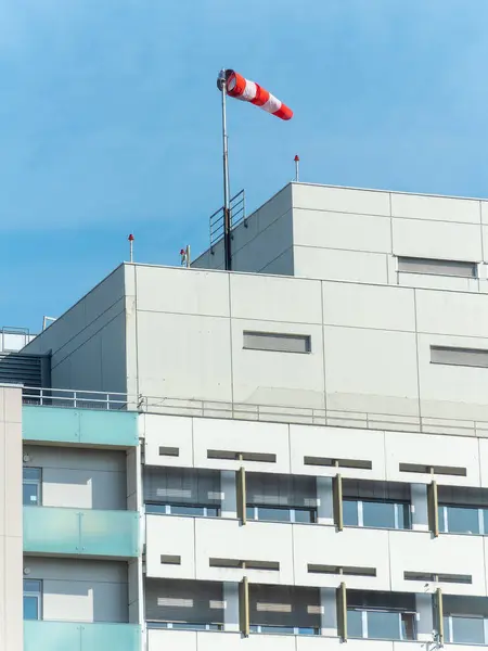 A windsock is a visual wind direction indicator on the top of the building