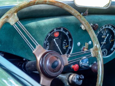 Klasik bir arabanın iç mekanına yakından bakınca klasik göstergeleri, zarif direksiyonları ve zengin dokuları olan, otomotiv tarihini kutlayan güzel tasarlanmış bir gösterge paneli ortaya çıkıyor..