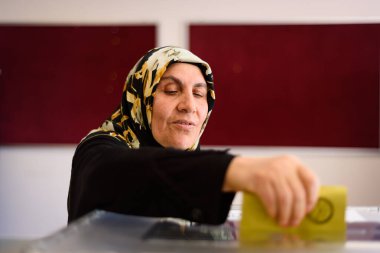 İstanbul, Türkiye, 14 Mayıs 2023 Saffet ebi okulundaki genel seçimlerde genç bir kadının oy kullandığı görülüyor. 64 milyon Türk vatandaşı oy kullanmak için sandık başına çağrıldı.