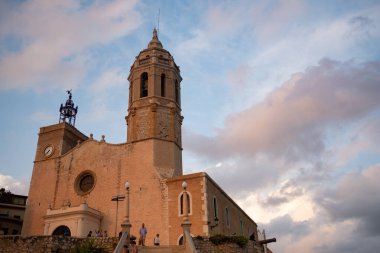 SITGES, SPAIN - 20 Ağustos 2022: Costa Dorada 'daki popüler turistik kentin Katedral ve gezinti alanı. Katalonya 'nın kıyı kenti Film Festivali ve Karnaval ile ünlüdür.