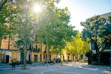Yaz günü Barcelona Poble Nou caddesinin manzarası. Bisiklet süren insanlarla dolu. Yazın İspanyol şehrinin sokak manzarası