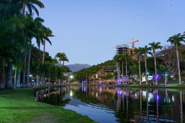 Beautiful scenery at sunset in El Laguito at Circulo Militar park in Caracas, Venezuela. Daily life and landmark of Caracas. clipart