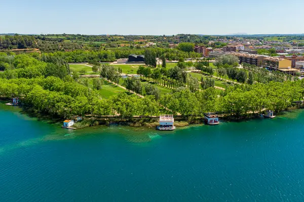 stock image Aerial view of Banyoles lake at sunrise in Girona, Catalonia, Spain. Drone shot of peaceful lake landscape in the morning with warm light at dusk