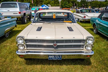Iola, WI - July 07, 2022: High perspective front view of a 1966 Ford Fairlane GTA Hardtop Coupe at a local car show. clipart