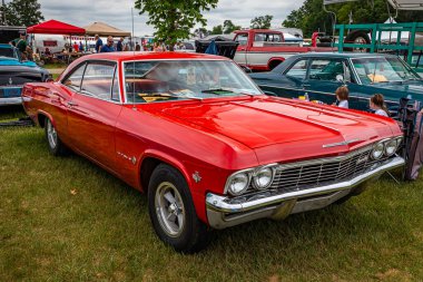 Iola, WI - 07 Temmuz 2022: 1965 Chevrolet Impala 2 Door Hardtop 'ın yüksek perspektifli ön köşesi yerel bir araba fuarında.