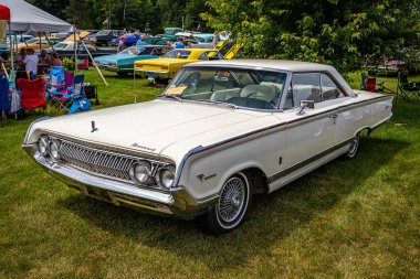 Iola, WI - July 07, 2022: High perspective front corner view of a 1964 Mercury Park Lane Marauder 2 Door Hardtop at a local car show.