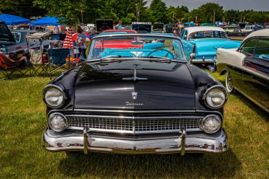 Iola, WI - July 07, 2022: High perspective front view of a 1955 Ford Fairlane Sunliner Convertible at a local car show.