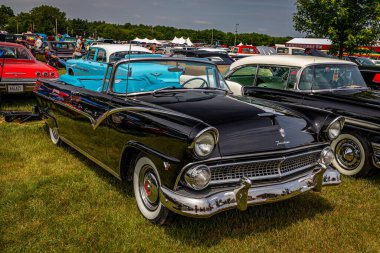 Iola, WI - July 07, 2022: High perspective front corner view of a 1955 Ford Fairlane Sunliner Convertible at a local car show.