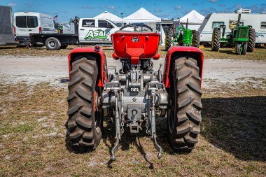 Fort Meade, FL - February 24, 2022: High perspective rear view of a 1967 Massey Ferguson 130 Diesel Tractor at a local tractor show.