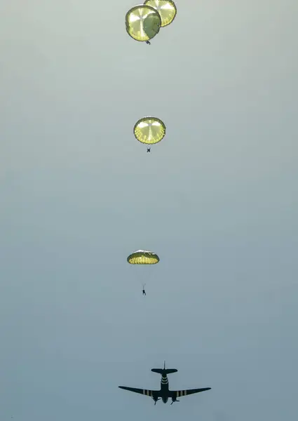 军用降落伞在战场中央的天空中飞行 — 图库照片