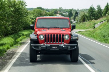 red car on road in the mountains clipart