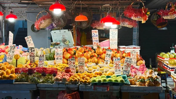 The traditional raw fruit shop in Hong Kong market at nighttime