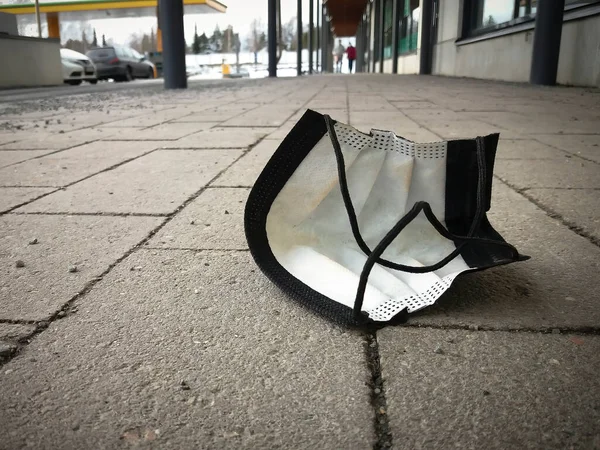 Dropped Corona mask on the street. Some people don\'t know where the trash can is.
