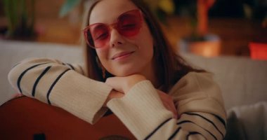 Portrait of Woman Playing Acoustic Guitar at Home Composing Music Songwriting