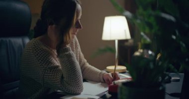 Portrait of Pensive Woman Working Late at Home Office. Contemplative Thoughtful Woman.