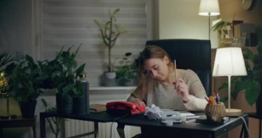 Portrait of Pensive Woman Working Late at Home Office. Contemplative Thoughtful Woman.