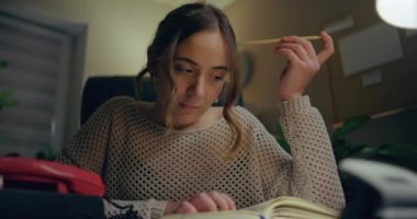 Portrait of Pensive Woman Working Late at Home Office. Contemplative Thoughtful Woman.