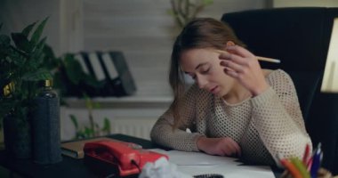 Portrait of Pensive Woman Working Late at Home Office. Contemplative Thoughtful Woman.