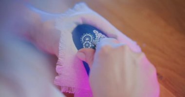 Kültürel ve dini bir gelenek olan geleneksel Paskalya yumurtalarını dekore eden kadın, çeşitli teknikleri kullanarak yumurtaları özenle boyuyor ve karmaşık tasarımlar ve sembolik tasvirlerle süslüyor.