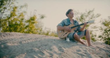 Güneşli bir günde ilham veren modern müzisyen gitaristin portresi.