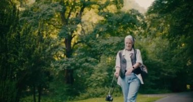 Gülümseyen kaygısız kadın ormanda yürürken ormanı keşfediyor.