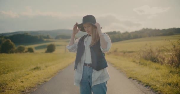Sad Young Woman Removing Hat While Standing Road Meadow Sky — Stock Video
