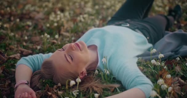 Smiling Female Explorer Resting While Lying Ground Flowers Garden — Stock Video