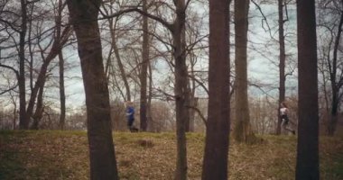 Aktif genç bir kadın bahçede ısınırken kız arkadaşıyla koşuyor.