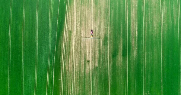 Drone shoot of farmer spraying Farm Land With Pesticides Farming Equipment Food Modification Crop Farming Concept