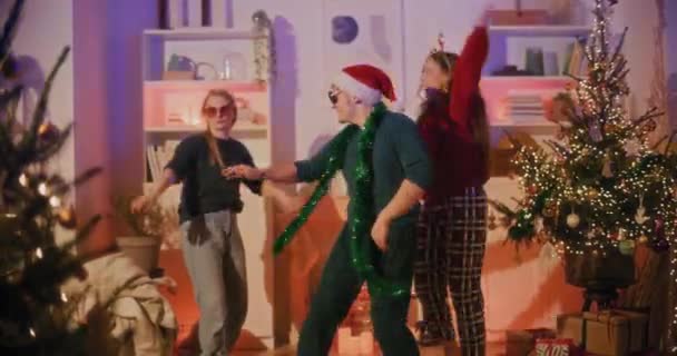 Glücklicher Junger Mann Tanzt Den Weihnachtsferien Hause Mit Freundinnen — Stockvideo