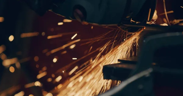 Close Up Of Sparks Cutting At Metal Industry Workshop. Grinding Metal Sparks Steel Cutting At Industrial Workshop