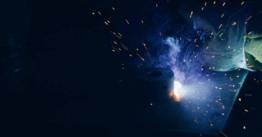 Close Up Of Bright Welding Sparks Welding Metal Parts At Steel Construction Industrial Workshop