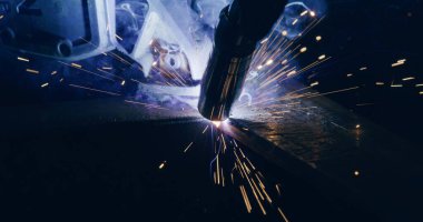 Close Up Of Bright Welding Sparks Welding Metal Parts At Steel Construction Industrial Workshop