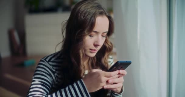 Ung Attraktiv Kvindelig Brunette Chatter Mobiltelefon Mens Dagen Drømmer Hjemme – Stock-video