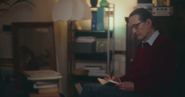 Yaşlı Bir Beyefendi Gece Vakti Kitap Okumaya Daldı Yumuşak Loş — Stok video