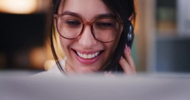 Bir iş kadınının yüzü telefonda konuşurken ve dizüstü bilgisayarla çalışırken yakın plan çekimleri..