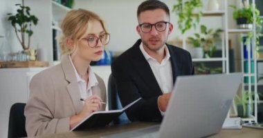 Business colleagues discuss in the office.