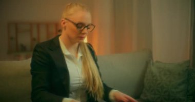 Takım elbiseli girişimci bir kadın bilgisayarını açar ve gece geç saatlere kadar çalışmaya başlar. Bir sonraki iş hamlesini planlar..