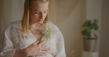 Bekleyen neşeli bir anne ilk çocuğuna mutluluk ve memnuniyet dolu bir ifadeyle değer verir..