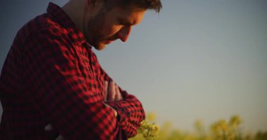 Kederli çiftçi tarlaya derin derin bakıyor, tarımdaki zorlukları yansıtıyor..