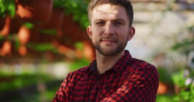 Seradaki mutlu genç bir çiftçinin portresi başarılı bir şekilde bahçe işleriyle uğraşıyor..