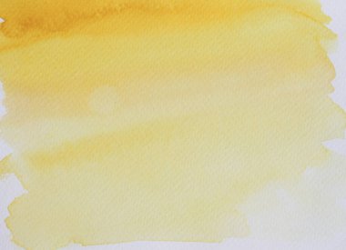 Beyaz kağıda suluboya vuruşu ve sprey, elle sarıya boyanmış, turuncu renkli sıvı damlalar.