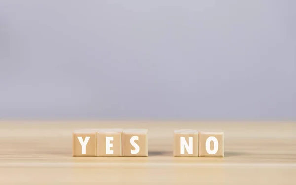 stock image The wooden block shows the letters yes or no. The concept of voting decisions think right and wrong Business options for difficult situations true and false symbols