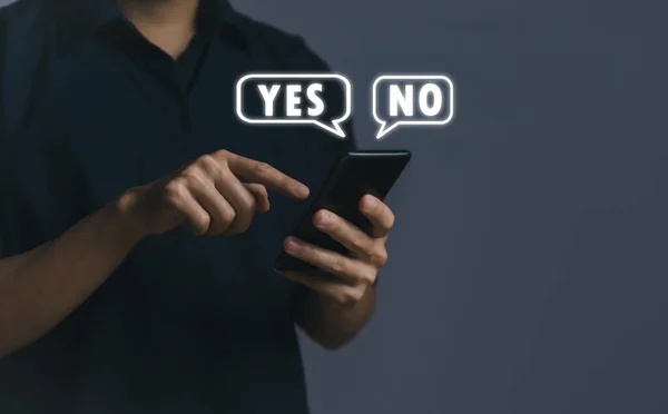 Businessman using smartphone to show yes or no. Concept of voting decision. think right or wrong Business options for difficult situations true and false symbols